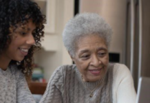 Minimizing The Risk of Financial Abuse For People Living With Dementia A woman shows her mother about social security.